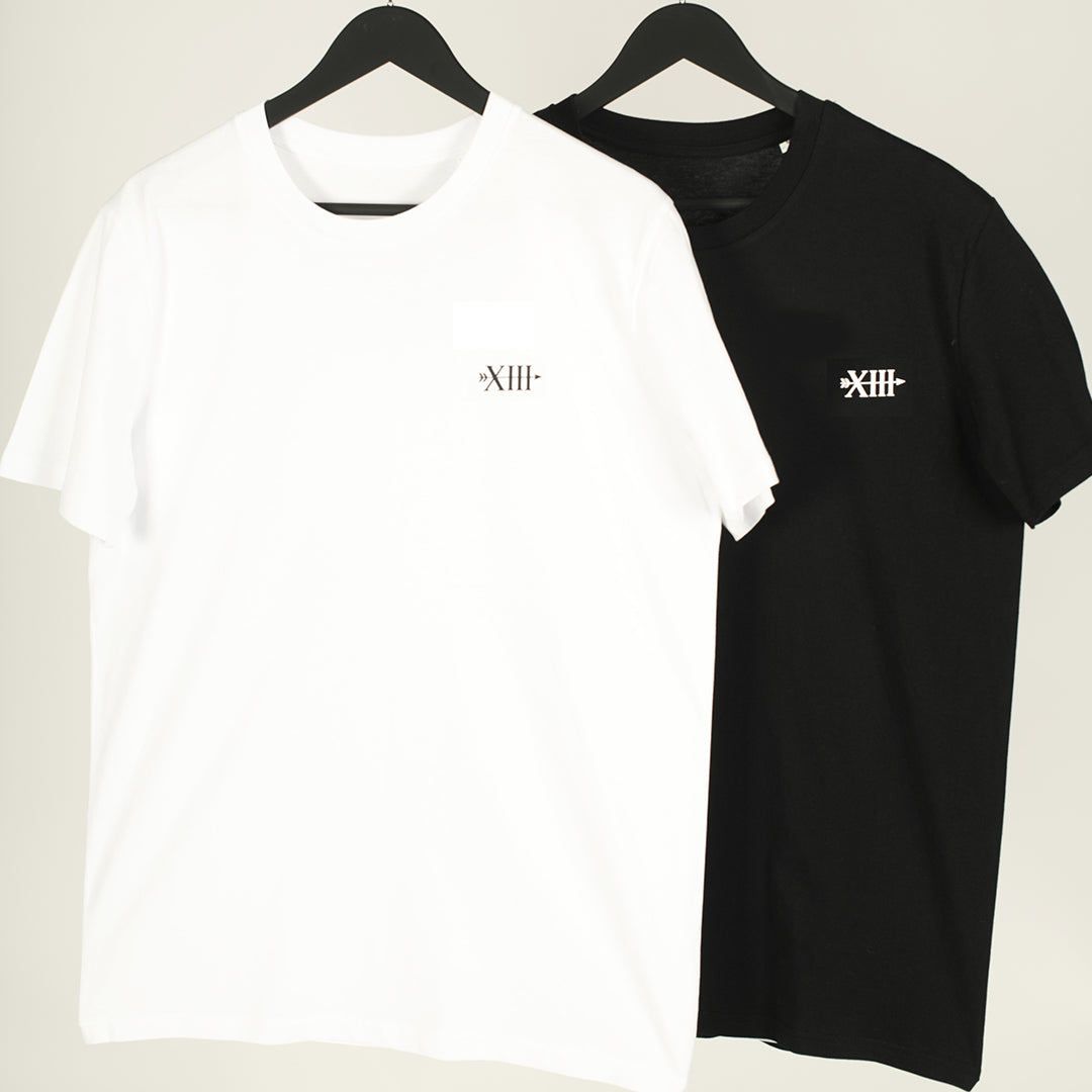 White Mindful Harmony t-shirt hanging flat, featuring minimalist yin and yang symbol
